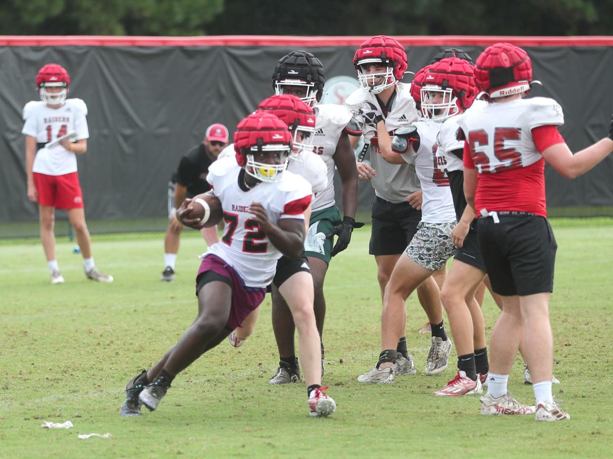 Savannah Christian running back Zo Smalls runs with the ball during practice.