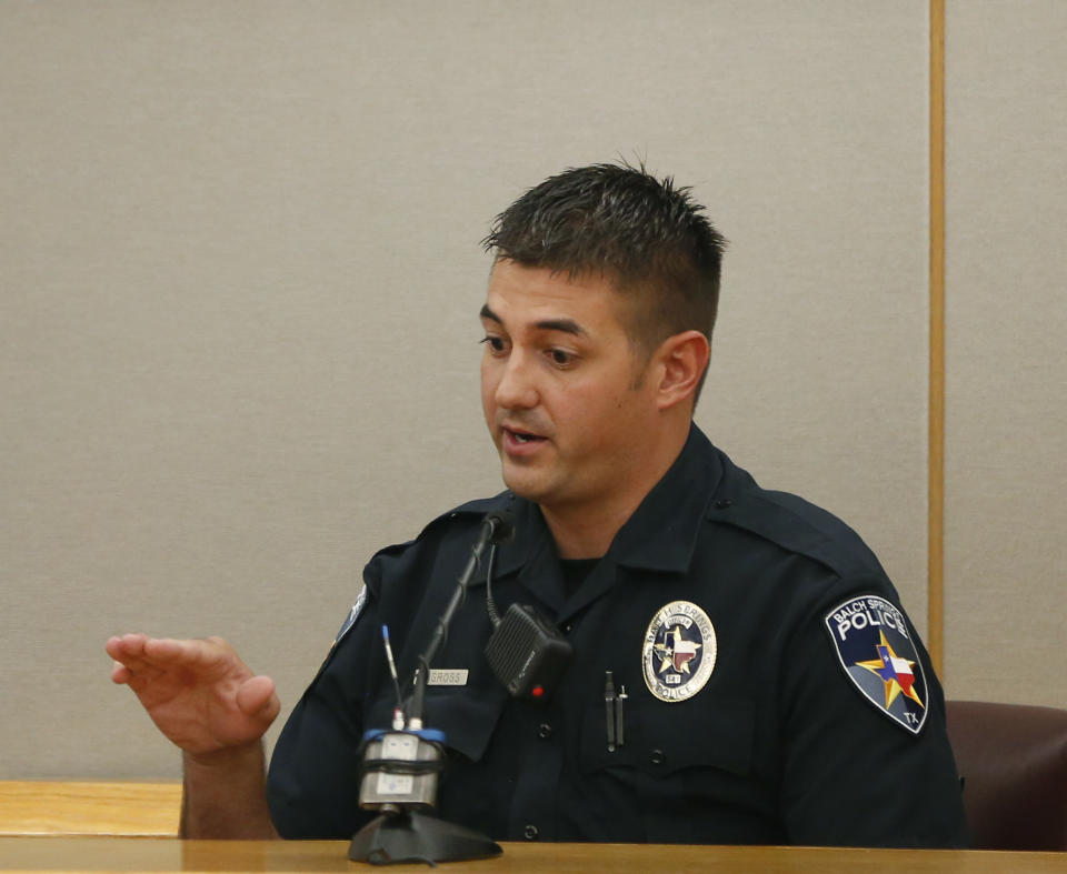 Balch Springs police officer Tyler Gross gives testimony for lead prosecutor Michael Snipes during the first day of the trial of fired Balch Springs police officer Roy Oliver, who is charged with the murder of 15-year-old Jordan Edwards, at the Frank Crowley Courts Building in Dallas on Thursday, Aug. 16, 2018. (Rose Baca/The Dallas Morning News via AP, Pool)