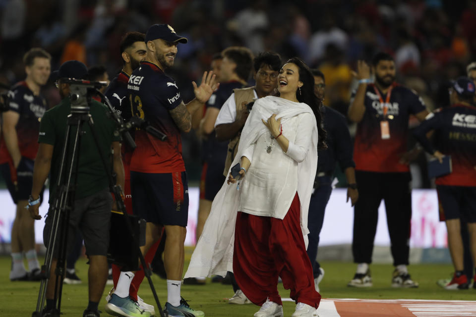 Bollywood actress and owner of Kings XI Punjab, Preity Zinta, shares light moment with Royal Challengers Bangalore's Faf du Plessis and Virat Kohli, after after they won against Punjab Kings during the Indian Premier League cricket match in Mohali, India, Thursday, April 20, 2023. (AP Photo/Surjeet Yadav)