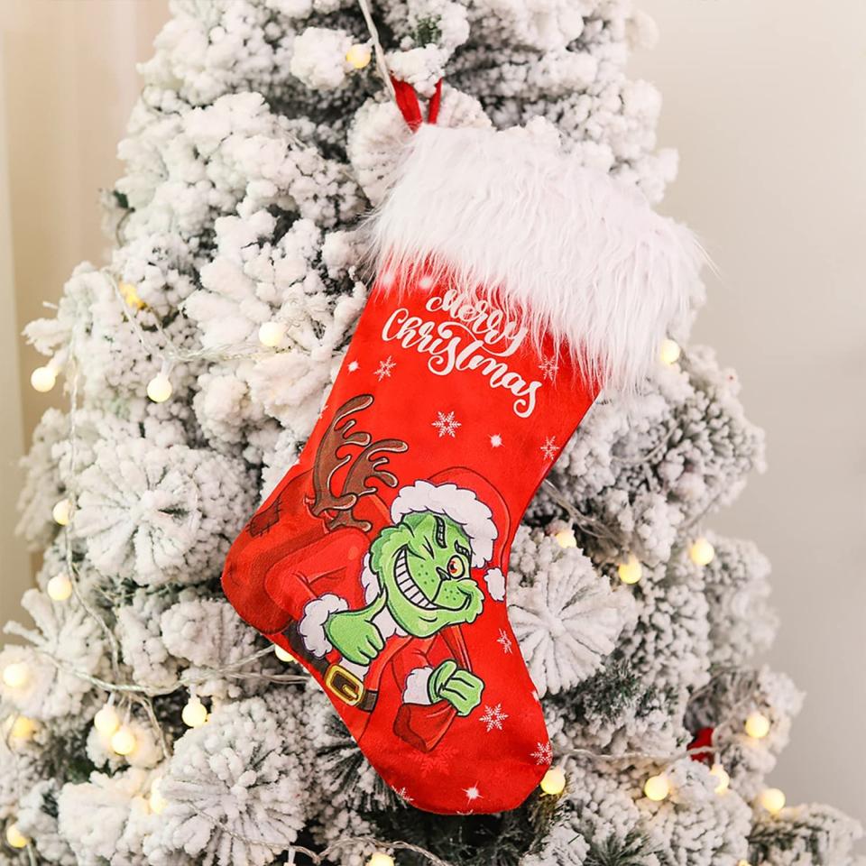 Adurself Christmas Stocking with grinch hanging on a flocked christmas tree