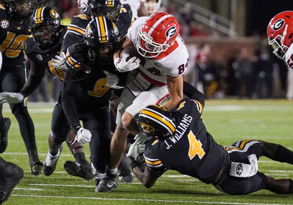 Oct 1, 2022; Columbia, Missouri, USA; Georgia Bulldogs wide receiver Ladd McConkey (84) is tacked by Missouri Tigers defensive back Jalani Williams (4) during the second half at Faurot Field at Memorial Stadium. Denny Medley-USA TODAY Sports