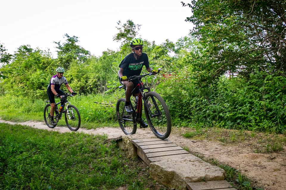 Otis Maclin, right, and Ray Haas ride their bicycles on the Creekside Flow Trails, Wednesday, May 31, 2023, at the Creekside Cross park in Coralville, Iowa.