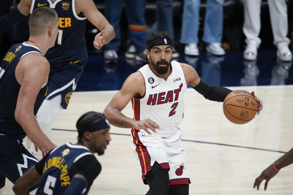 Miami Heat guard Gabe Vincent (2) moves the ball against the Denver Nuggets during the first half of Game 2 of basketball's NBA Finals, Sunday, June 4, 2023, in Denver. (AP Photo/David Zalubowski)