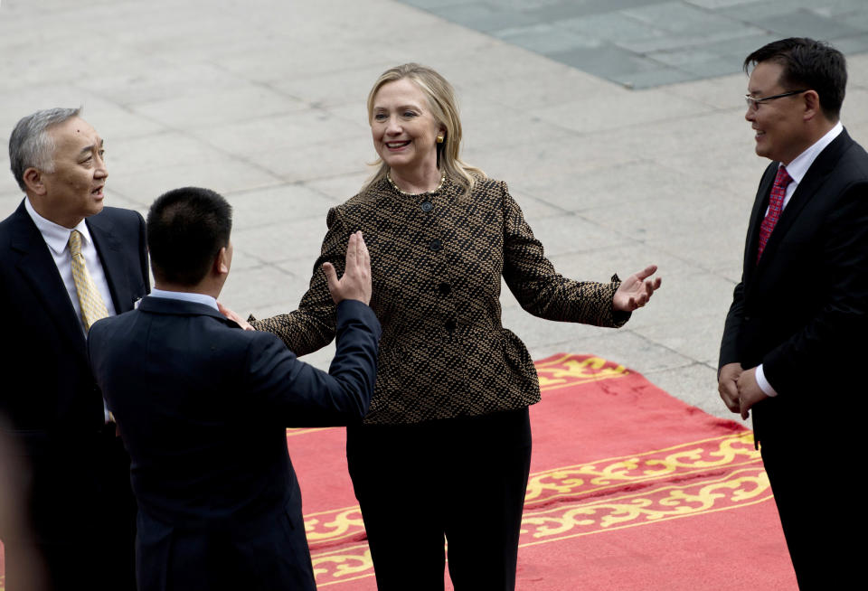 U.S. Secretary of State Hillary Rodham Clinton, center, is greeted during an arrival ceremony at the Government House Monday, July 9, 2012 in Ulan Bator, Mongolia. (AP Photo/Brendan Smialowski, Pool)