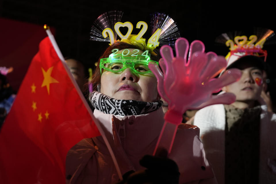 Revelers prepare for a countdown to the new year in Beijing, Sunday, Dec. 31, 2023. (AP Photo/Ng Han Guan)