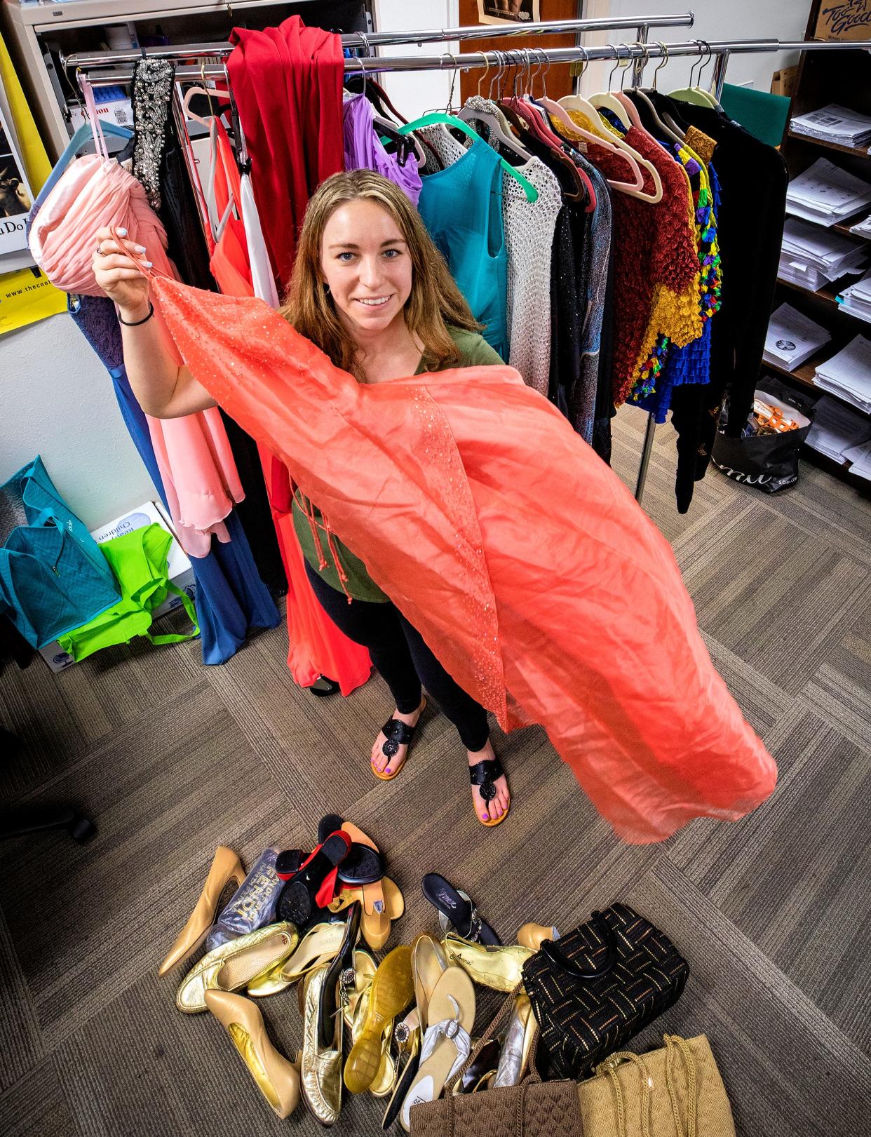 Sam McCain, Assistant Executive Director of InnerAct Alliance with donated prom dresses they have collected for high school students and will be available at their Project Prom store at Lakeland Square mall in Lakeland Fl. Wednesday March 9,  2022.  
ERNST PETERS/ THE LEDGER