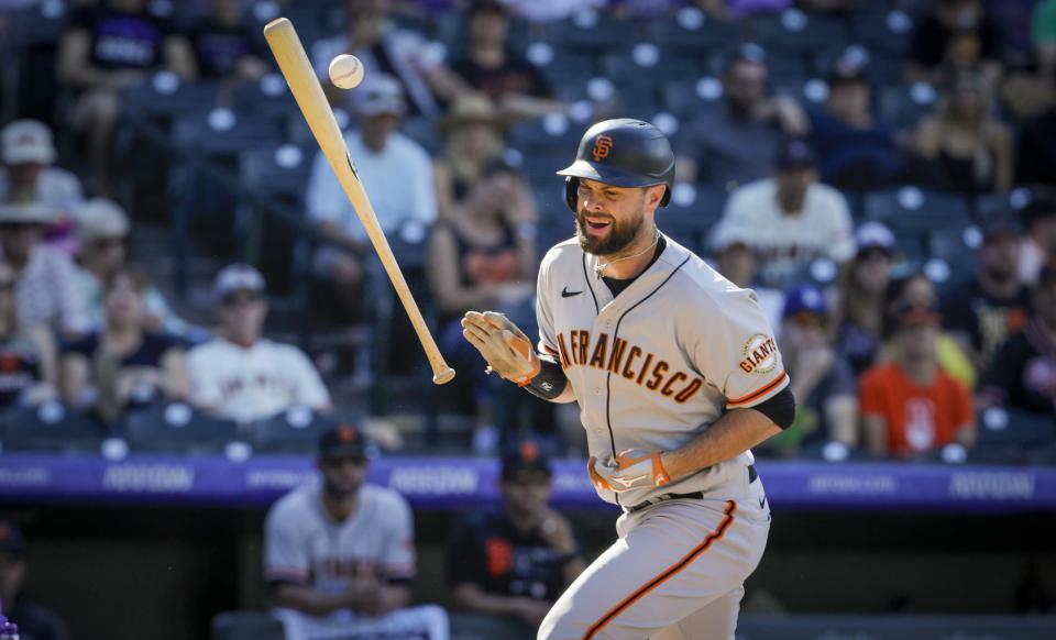 San Francisco Giants' Brandon Belt (9) is hit by a pitch from Colorado Rockies reliever Lucas Gilbreath in the seventh inning of a baseball game in Denver, Sunday, Sept. 26, 2021. (AP Photo/Joe Mahoney)