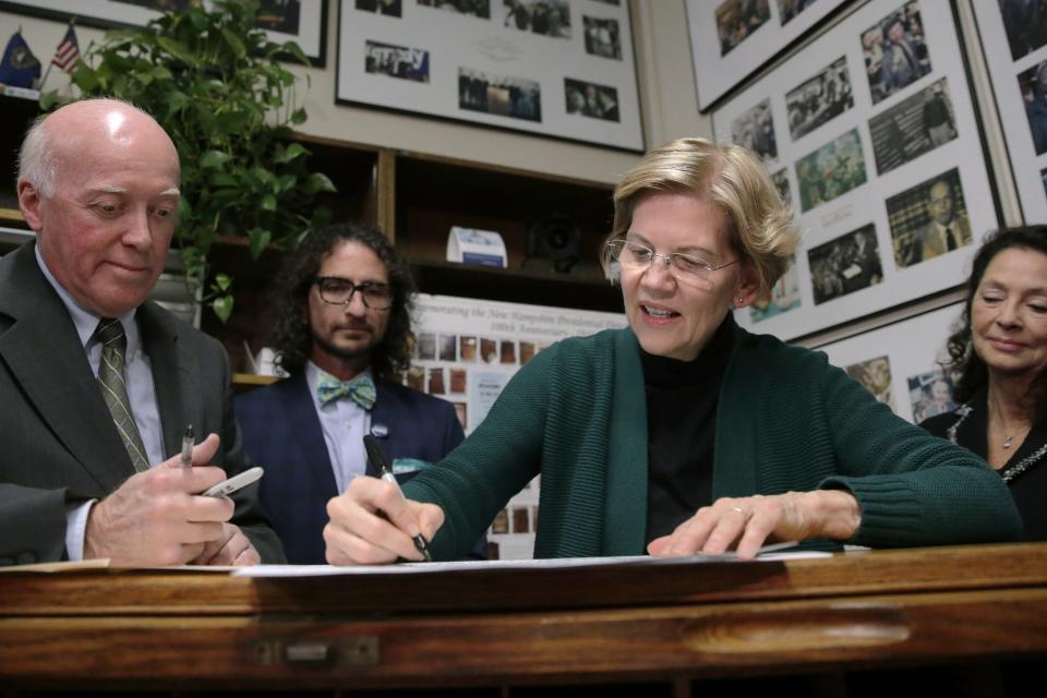 Democratic presidential candidate U.S. Sen. Elizabeth Warren, D-Mass., files to have her name listed on the New Hampshire primary ballot, Wednesday, Nov. 13, 2019, in Concord, N.H. At left is New Hampshire Secretary of State Bill Gardner. (AP Photo/Charles Krupa)