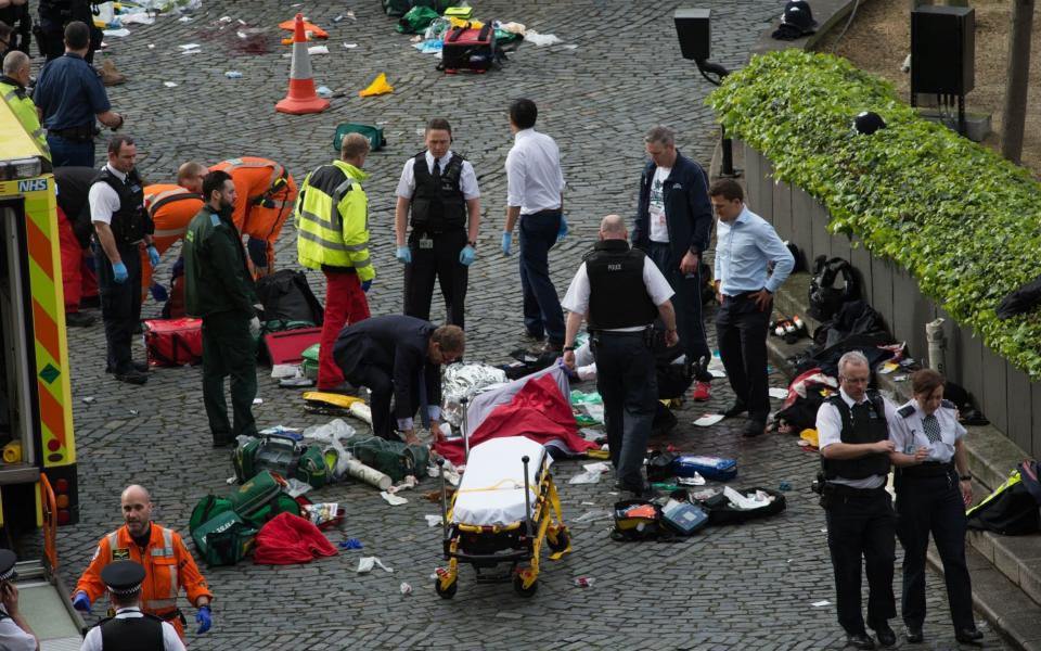 Conservative MP Tobias Ellwood stands amongst the emergency services at the scene outside the Palace of Westminster, London, after policeman has been stabbed and his apparent attacker shot by officers in a major security incident at the Houses of Parliament