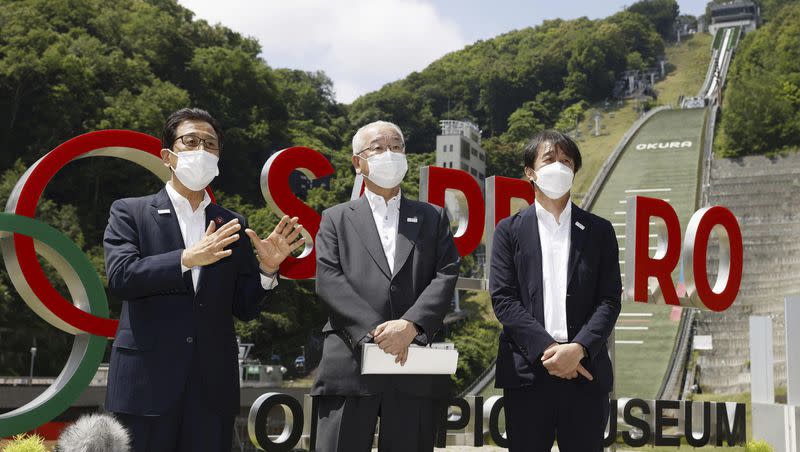 Sapporo Mayor Katsuhiro Akimoto, left, speaks during a news conference at a proposed site for the Winter Olympics ski jump in Sapporo, northern Japan, on July 30, 2022.