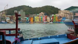 七彩的建築物搭配著五顏六色的漁船。 | The bay overlooking Heping Bridge and the row of pastel-colored buildings – multicolored fisherman boats docked along the boardwalk. (Courtesy of Greg)