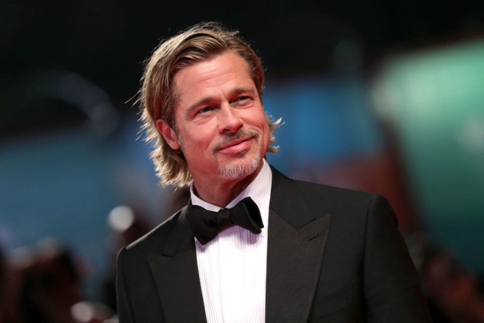 Brad Pitt smiles and wears a tux