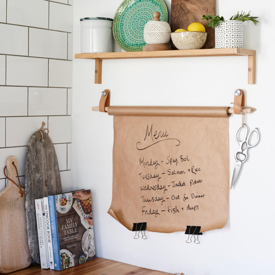 <p> By simply attaching two handles and a length of dowel to a wall you can create a storage solution for all manner of kitchen accessories. From foil to kitchen towel, the possibilities are endless. Above we see how two leather handles are making a stylish support for a kitchen memo board, on a roll of brown paper. </p>