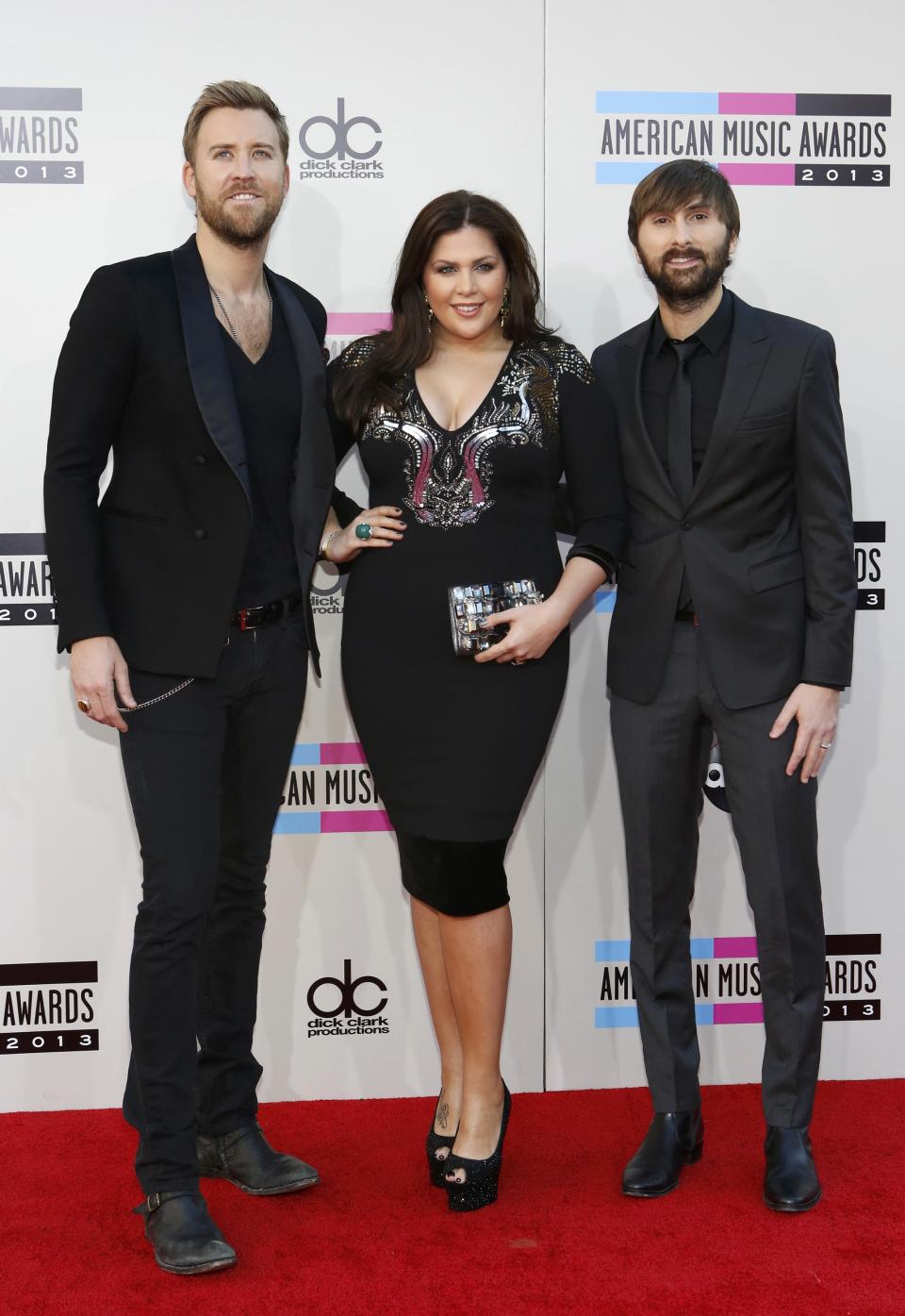 Charles Kelley (L), Hillary Scott and Dave Haywood of Lady Antebellum arrive at the 41st American Music Awards in Los Angeles, California November 24, 2013. REUTERS/Mario Anzuoni (UNITED STATES - Tags: ENTERTAINMENT) (AMA-ARRIVALS)