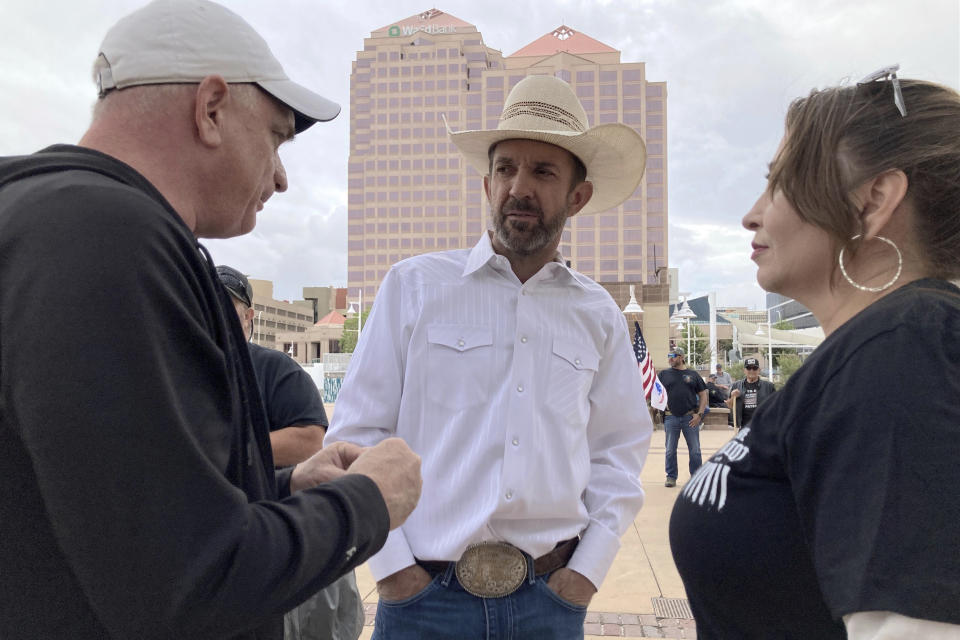 Couy Griffin, center, talks with supporters during a rally, Tuesday, Sept. 12, 2023 in Albuquerque, N.M. Griffin traveled from Alamogordo, NM, to support those protesting New Mexico Gov. Michelle Lujan Grisham's order on Friday suspending the open and concealed carry of guns in most public places. (AP Photo/Susan Montoya Bryan)