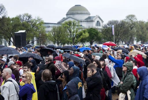 People listen during the Reason Rally on the National Mall in Washington, DC. Thousands of atheists, agnostics and other non-believers turned out in the US capital on Saturday to celebrate their rejection of the idea of God and to claim a bigger place in public life