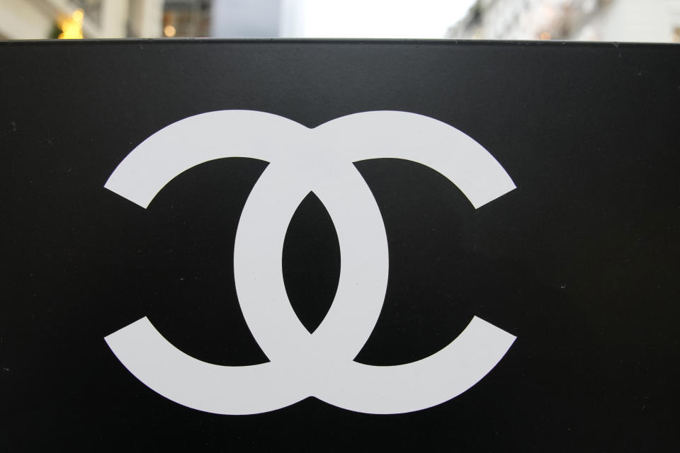 Chanel logo is pictured on a valet sign outside a Chanel boutique Wednesday, Dec. 15, 2021 in Paris. The French luxury fashion house Chanel has chosen Leena Nair, an industry outsider from India and longtime executive at Unilever, to be its new CEO. (AP Photo/Christophe Ena)