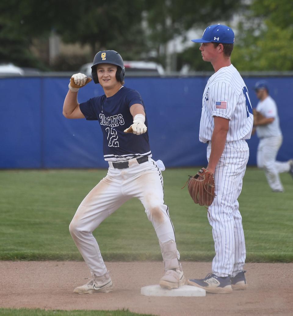 Noah Stevens of Whiteford jesters a bow and arrow after hitting a double to score two runs in the first inning of Dundee May 20, 2024, second baseman Evan Bennett looking on for Dundee.