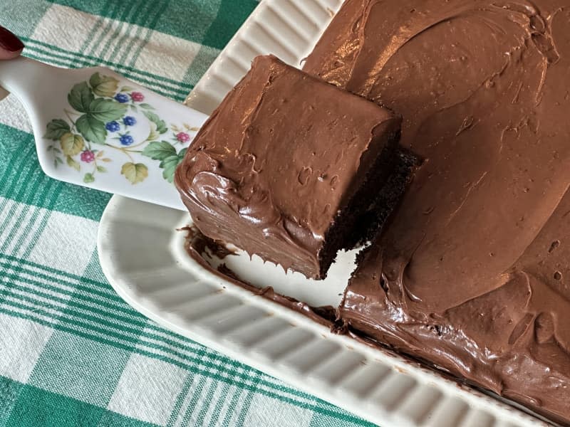 Dolly Parton's Duncan Hines favorite chocolate cake in a pan with one slice on cake server