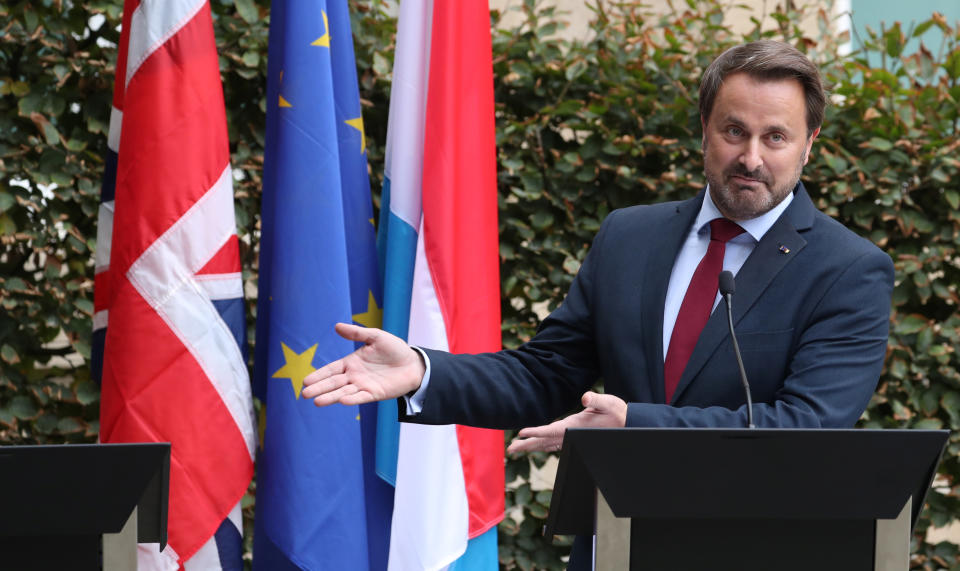 Luxembourg's Prime Minister Xavier Bettel gestures at the space left for Boris Johnson after the Prime Minister pulled out of a news conference (Reuters)