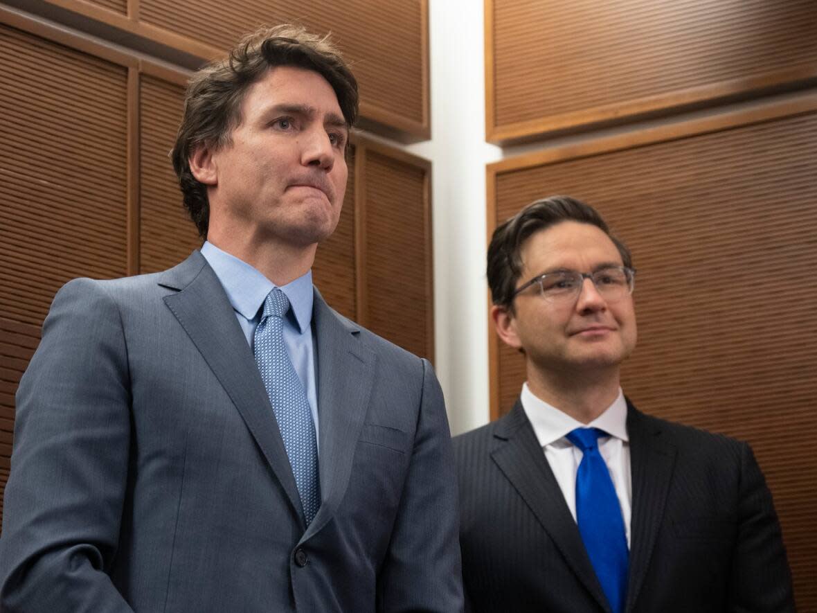 Prime Minister Justin Trudeau stands next to Conservative Leader Pierre Poilievre at a Tamil heritage month reception in Ottawa. Trudeau and Poilievre traded pointed barbs in questions period Wednesday. (Adrian Wyld/Canadian Press - image credit)