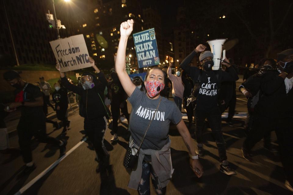 Activists march to the Brooklyn Bridge on Sunday, May 31, 2020, in New York. Demonstrators took to the streets of New York to protest the death of George Floyd, who died May 25 after he was pinned at the neck by a Minneapolis police officer. (AP Photo/Kevin Hagen).