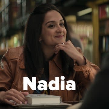 Nadia smiling in a library