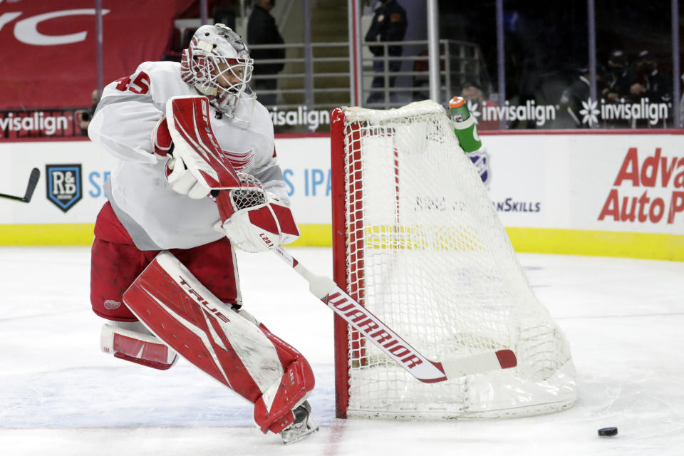 Detroit Red Wings' goaltender Jonathan Bernier (45) plays the puck during the second period of an NHL hockey game against the Carolina Hurricanes in Raleigh, N.C., Thursday, March 4, 2021. (AP Photo/Chris Seward)