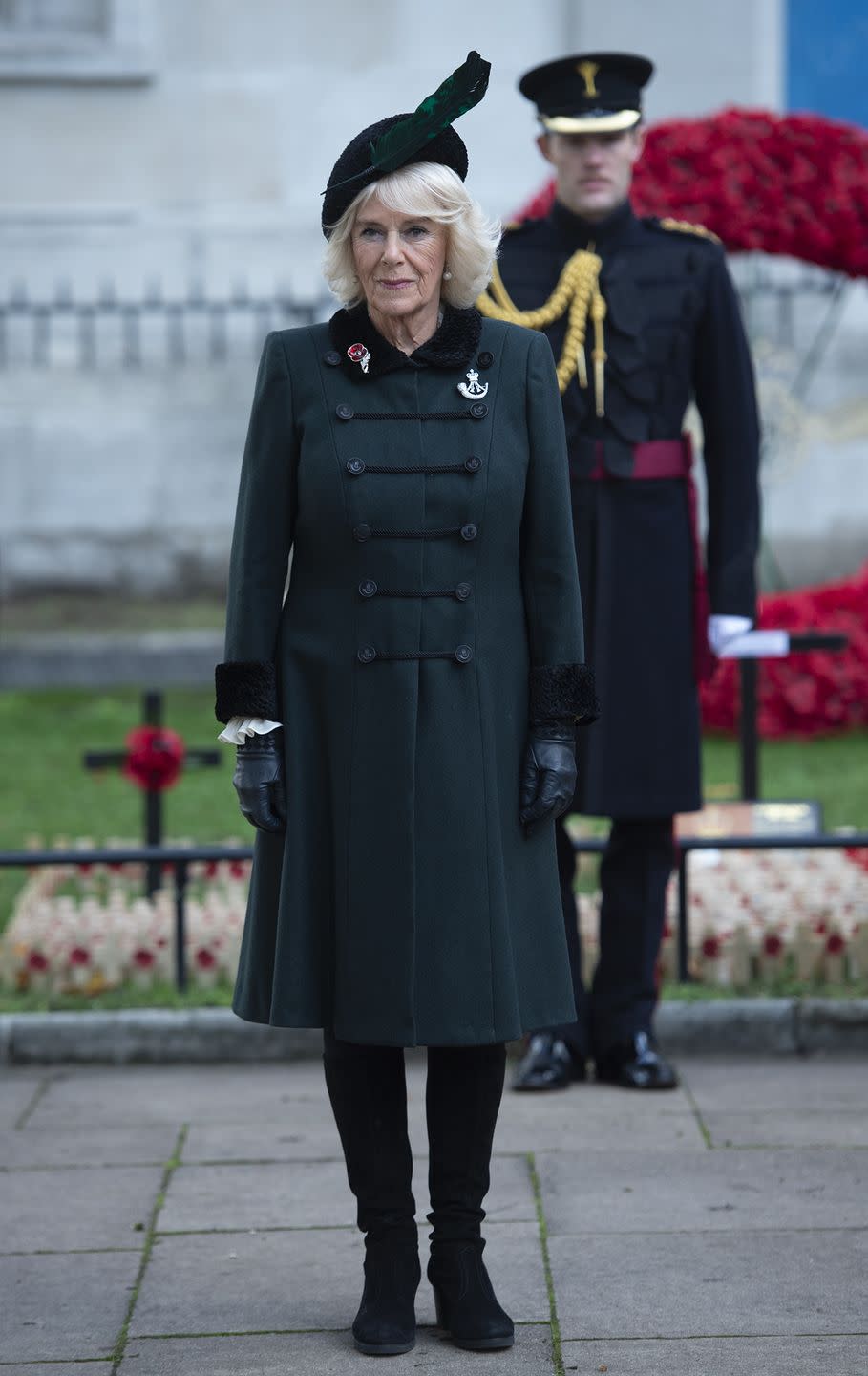 <p>Camilla, Duchess of Cornwall, wore an emerald and black fur-trimmed coat and black leather gloves while attending the 92nd Field of Remembrance at Westminster Abbey. She topped off the look with a black hat embellished with a feather.</p>