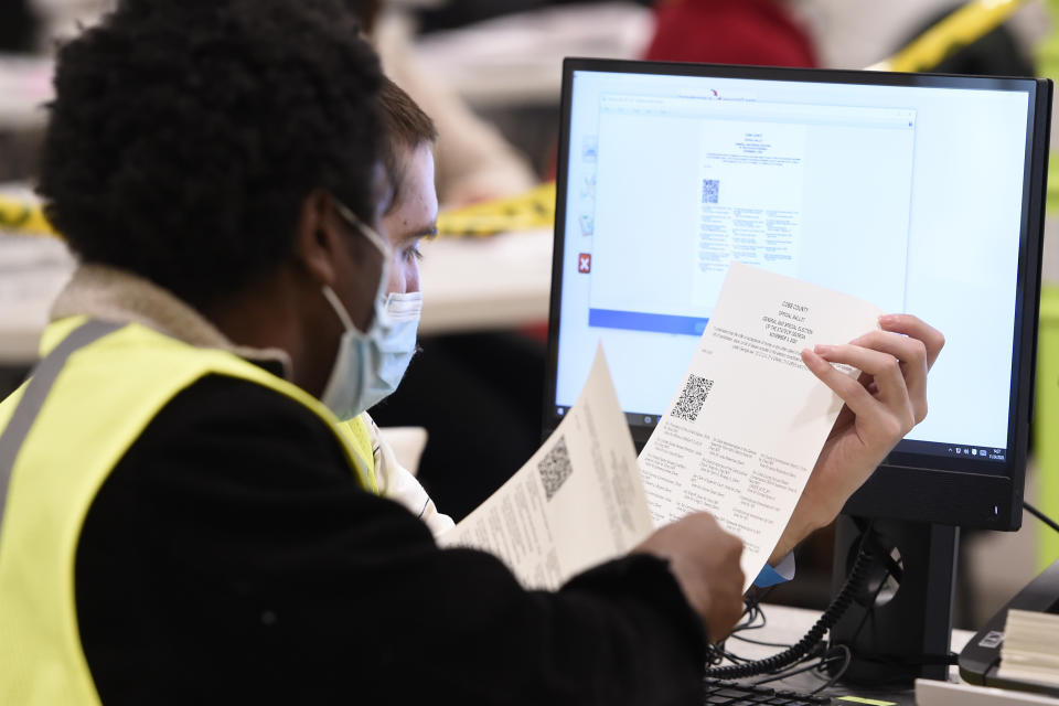 Cobb County Election officials look at ballots during a recount on Nov. 24, 2020, in Marietta, Ga. (Mike Stewart/AP)