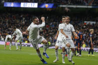 Real Madrid's Dani Carvajal, left, celebrates after Valencia's Daniel Wass scored an own goal during a Spanish La Liga soccer match between Real Madrid and Valencia at the Santiago Bernabeu stadium in Madrid, Spain, Saturday, Dec. 1, 2018. (AP Photo/Paul White)