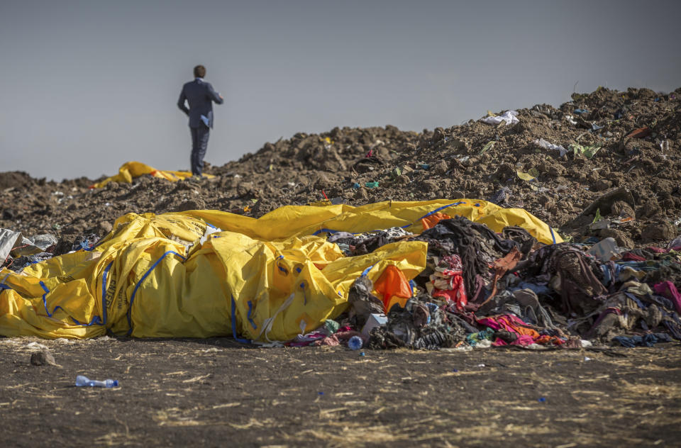 Wreckage lies at the scene where the Ethiopian Airlines Boeing 737 Max 8 crashed shortly after takeoff on Sunday killing all 157 on board, near Bishoftu, or Debre Zeit, south of Addis Ababa, in Ethiopia Tuesday, March 12, 2019. Ethiopian Airlines had issued no new updates on the crash as of late afternoon Tuesday as families around the world waited for answers, while a global team of investigators began picking through the rural crash site. (AP Photo/Mulugeta Ayene)