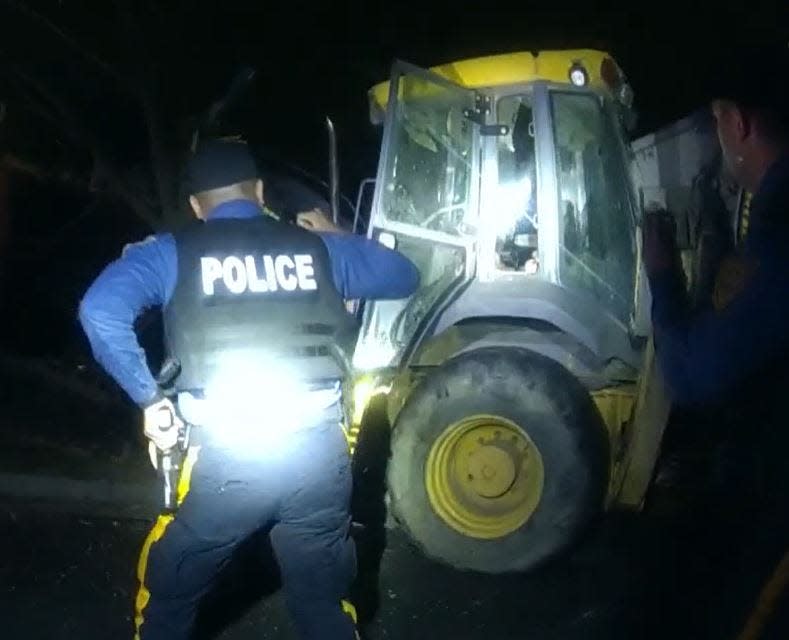 Vineland police officers approach a backhoe after the fatal shooting of Joshua Gonzalez, 20, of Millville on Dec. 18.