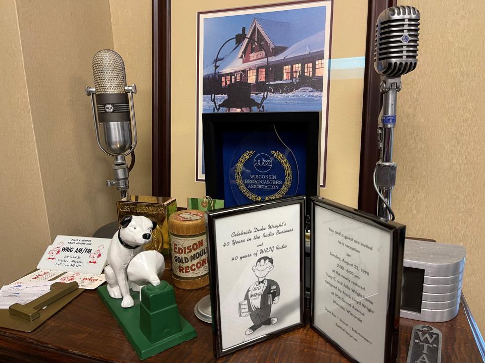 Radio memorabilia in Duke Wright's office at Midwest Communications is displayed on top of an antique Wurlitzer jukebox his dad once rented out from his music store in Wausau.