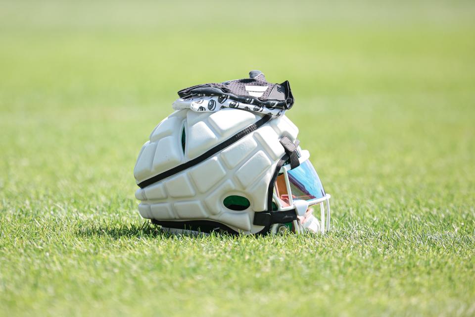 Jul 27, 2024; Florham Park, NJ, USA; A New York Jets helmet covered by a guardian cap and gloves rests on the field during training camp at Atlantic Health Jets Training Center. Mandatory Credit: Vincent Carchietta-USA TODAY Sports