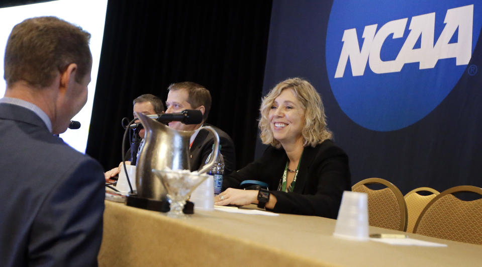 FILE - Robin Harris, right, executive director of the Ivy Leage, talks with a delegate at the NCAA Convention Thursday, Jan. 19, 2017, in Nashville, Tenn. A federal lawsuit filed by a pair of basketball players from Brown University alleges the Ivy League’s policy of not offering athletic scholarships amounts to a price-fixing agreement that denies athletes proper financial aid and payment for their services. The lawsuit was filed Tuesday, March 7, 2023, in U.S. District Court in Connecticut. (AP Photo/Mark Humphrey, File)