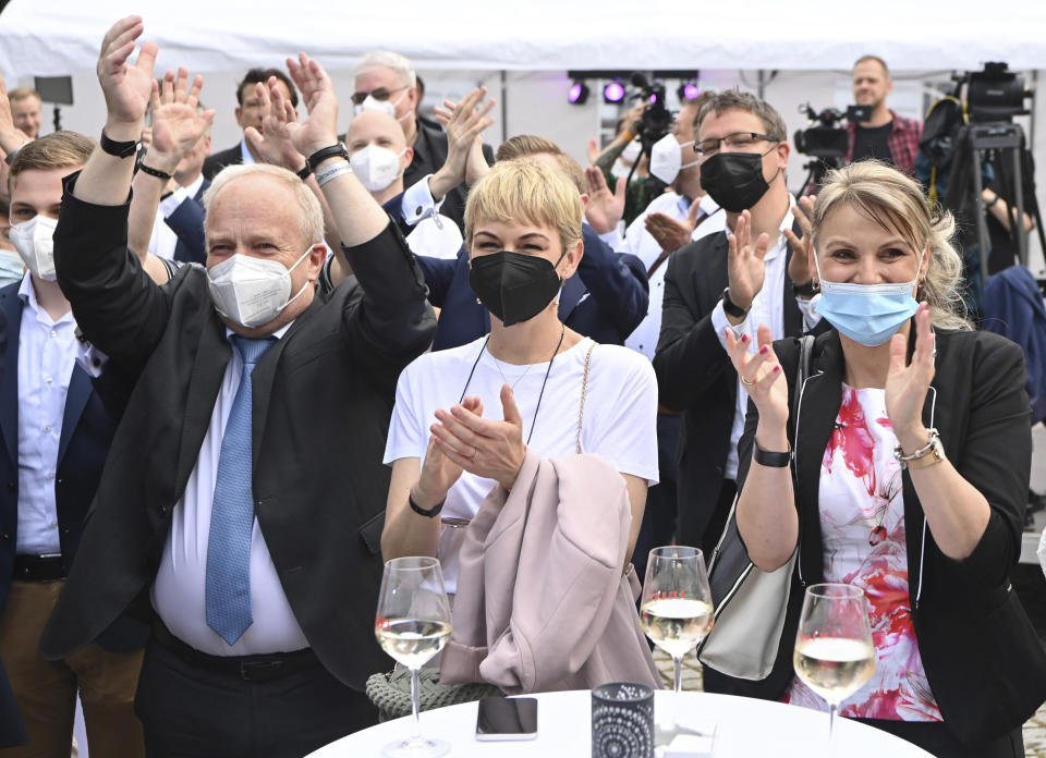 Supporters of Merkel's Christian Democratic Union party, CDU, react after firs exit poll for the Saxony-Anhalt state elections announced in Magdeburg, Germany, Sunday, June 6, 2021. The election for the new state parliament in Saxony-Anhalt was the last state election before the federal election in September 2021. (Bernd Von Jutrczenka/dpa via AP)