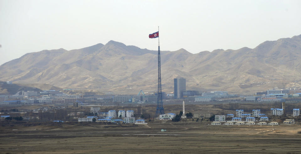 FILE - North Korea's flag flies on a tower high above the village of Ki Jong Dong, as seen from Observation Post Ouellette in the Demilitarized Zone, DMZ, the tense military border between the two Koreas, in Panmunjom, Korea, March 25, 2012. A series of low-slung buildings and somber soldiers dot the landscape of the DMZ, the swath of land between North and South Korea where a soldier on a tour crossed into North Korea on Tuesday, July 18, 2023, under circumstances that remain unclear. (AP Photo/Susan Walsh, File)
