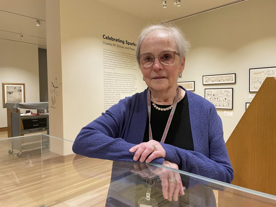 Lucy Shelton Caswell, founding curator of the Billy Ireland Cartoon Library Museum, is seen at a new museum exhibit about "Peanuts" creator Charles Schulz," on Friday, May 20, 2022, in Columbus, Ohio. Caswell curated the display, "Celebrating Sparky: Charles M. Schulz and Peanuts," one of a series of exhibits this year commemorating the centenary of the birth of Schulz. (AP Photo/Patrick Orsagos)