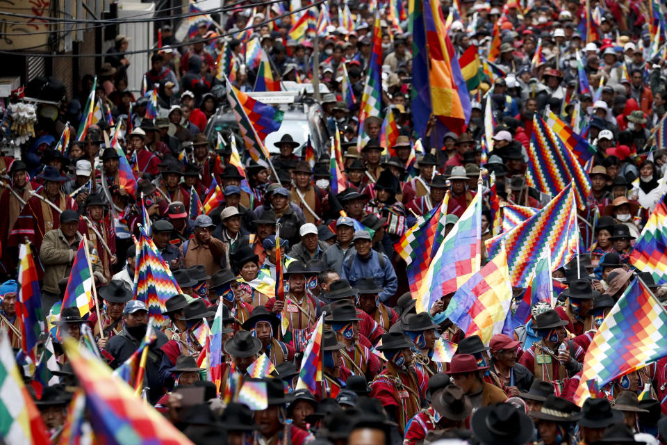 Backers of former President Evo Morales march in La Paz, Bolivia, Thursday, Nov. 14, 2019. Morales resigned and flew to Mexico under military pressure following massive nationwide protests over alleged fraud in an election last month in which he claimed to have won a fourth term in office. (AP Photo/Natacha Pisarenko)