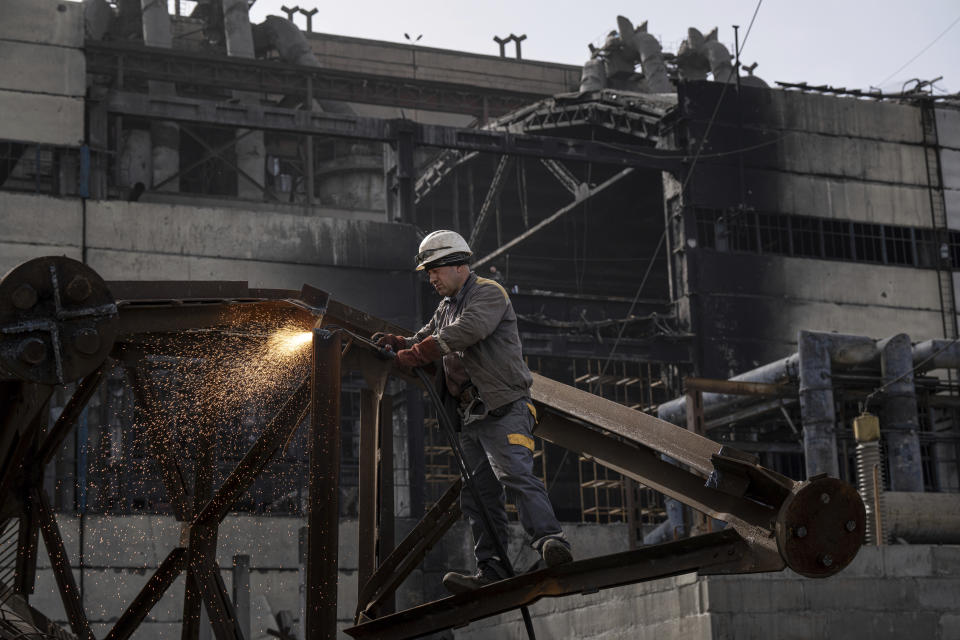 A worker cuts metal after a Russian missile attack at DTEK's power plant in Ukraine, on Monday, April 1, 2024. Russia is attacking Ukraine’s energy sector with renewed intensity and alarming accuracy, signaling to Ukrainian officials that Russia is armed with better intelligence and fresh tactics in its campaign to annihilate the country’s power generation capacity. (AP Photo/Evgeniy Maloletka)