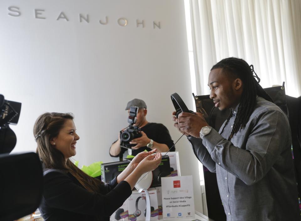 This May 6, 2014 photo shows NFL Draft prospect Calvin Pryor, a safety from Louisville, holding a pair of headphones at the 5th Annual NFL Pre-Draft Gifting & Style Suite at the Sean John show room in New York. Pryor is among dozens of prospects on the National Football League's annual draft, with 32 players per round and seven rounds, beginning Thursday night at Radio City. (AP Photo/Frank Franklin II)