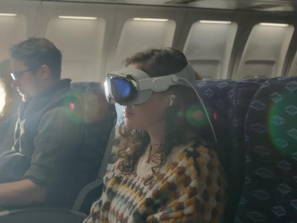 Apple's Vision Pro being used by a woman on an airplane.