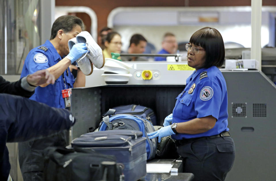 Transportation Security Administration are considered essential and are still expected to come to work -- but they're not being paid for it. (Photo: Elaine Thompson/Associated Press)