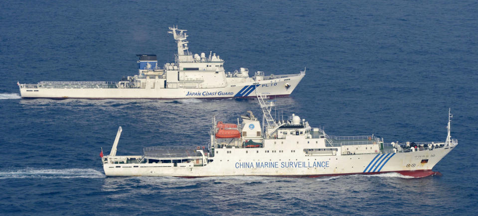 Ships of China Marine Surveillance and Japan Coast Guard sail side by side near disputed islands, called Senkaku in Japan and Diaoyu in China, in the East China Sea Tuesday afternoon, Sept. 18, 2012. The disagreement between the two countries escalated last week when the Japanese government said it was purchasing some of the islands from their private owner. (AP Photo/Kyodo News) JAPAN OUT, MANDATORY CREDIT, NO LICENSING IN CHINA, HONG KONG, JAPAN, SOUTH KOREA AND FRANCE
