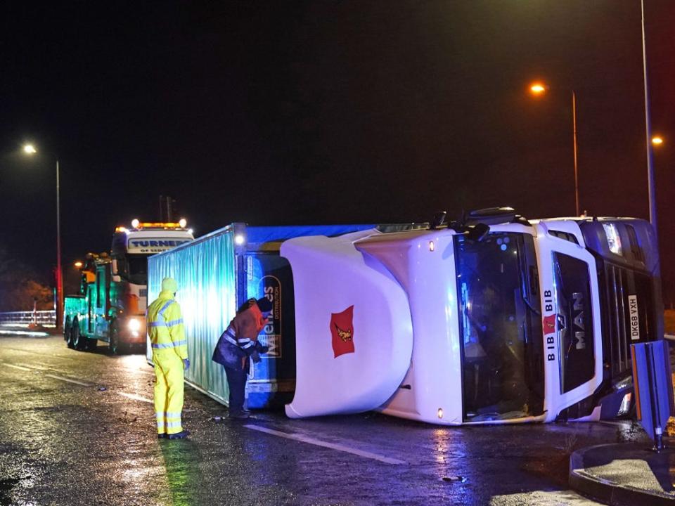 A lorry blown over in high winds blocks the A179 near Hartlepool, as gusts reached nearly 100mph in the northeast (PA)