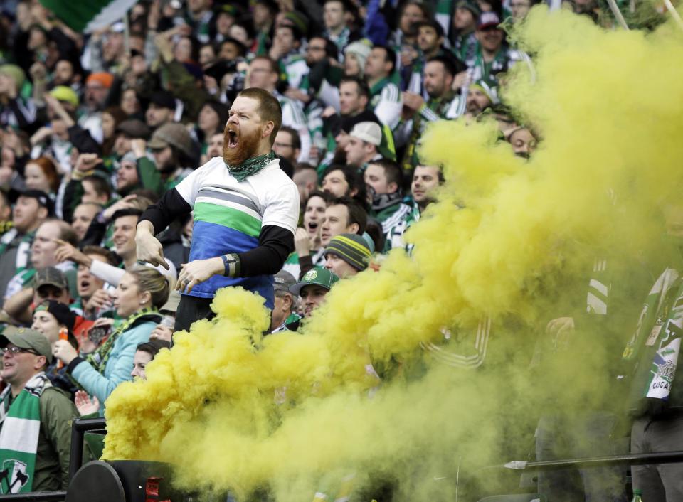 A Portland Timbers fan celebrates a goal during the second half of an MLS soccer game against the Seattle Sounders in Portland, Ore., Saturday, April 5, 2014. The teams tied 4-4. (AP Photo/Don Ryan)