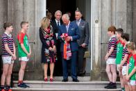 <p>Charles is gifted a pair of jerseys by local schoolchildren, during a visit to Palace Demense in Armagh, Northern Ireland.</p>