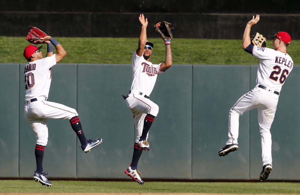 Minnesota Twins outfielders Eddie Rosario, left, Byron Buxton and Max Kepler, right, show their basketball 3-point form after the Twins beat the Toronto Blue Jays 13-7 on Sunday. (AP)