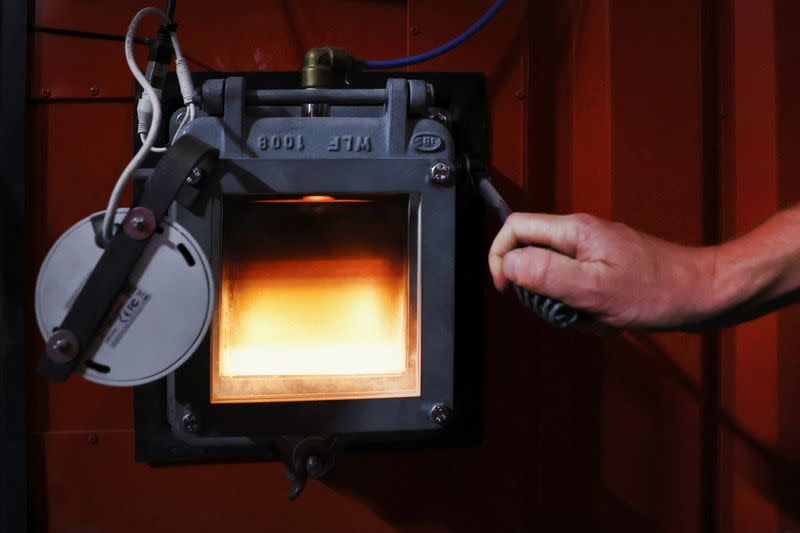 The furnace of a biomass generator is seen through a window at a greenhouse in Grubbenvorst